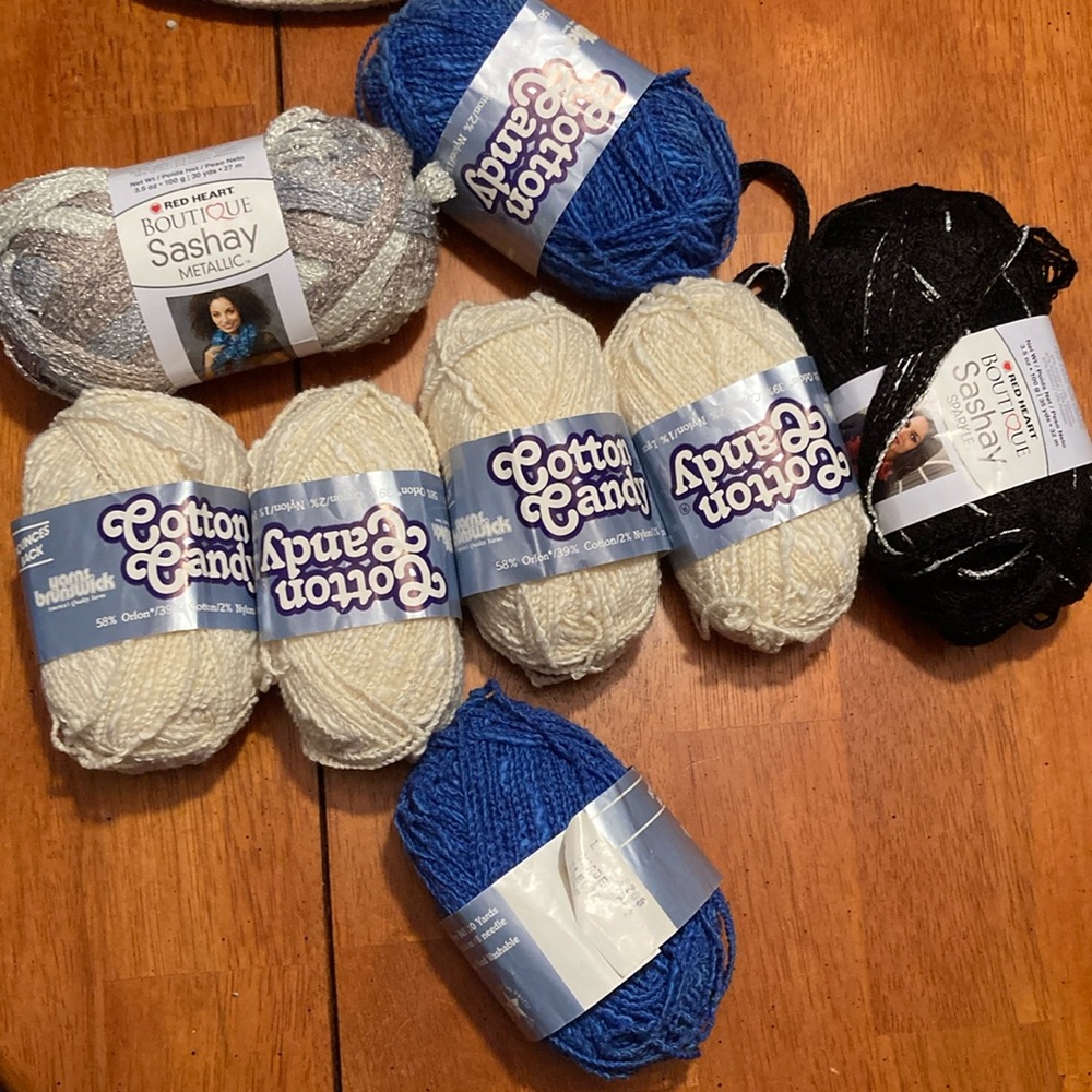 Yarn-8 skeins. 2 Sashay metallic (black/silver). 6 cotton Candy (cream/blue)